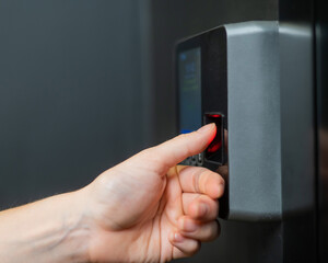 A woman opens the door with her fingerprint. Modern keyless entry lock. 