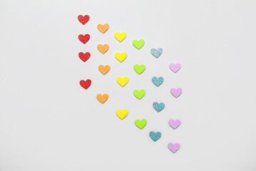 Hearts in colors of LGBT flag on grey background. Valentine's Day celebration