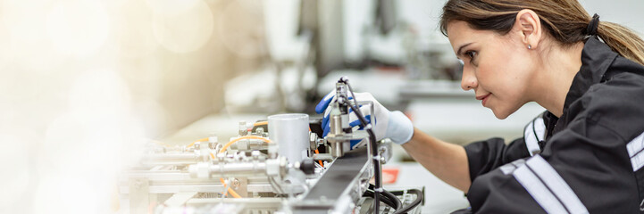 Banner Team woman of engineers practicing maintenance Taking care and practicing maintenance of old machines in the factory so that they can be used continuously.
