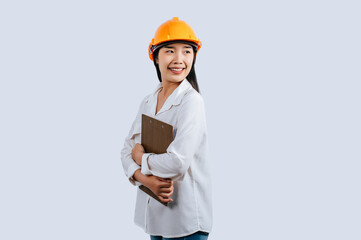 Young female engineer wearing Yellow helmet and clipboard