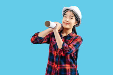 Young female engineer wearing white safety helmet with Blueprints