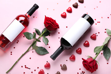 Composition with bottles of wine, rose flower and chocolate candies on pink background. Valentine's...