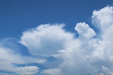 Naklejka na ściany i meble Beautiful view on blue sky with shaped clouds