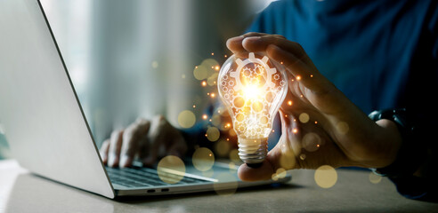 Hands holding light bulb for Concept new idea concept