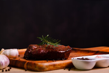 Meat steak with rosemary and ingredient on black copy space background for menu restaurant or recipe text.