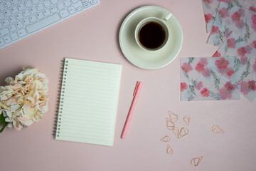 Writing letter concept with coffee, notebook, envelope over the pink background. 