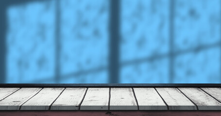Image of wooden platform and blue window shadow and rain drops