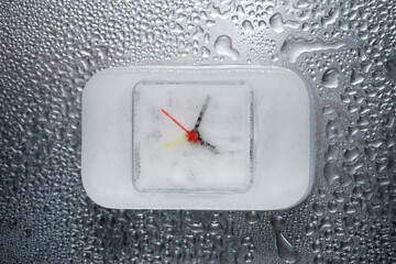 Overhead view of frozen clock on wet table