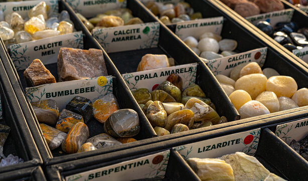 market stall of natural gemstones in boxes. Mineral stones for healing, altar, meditation, reiki, spiritual practice, ritual, witchcraft.