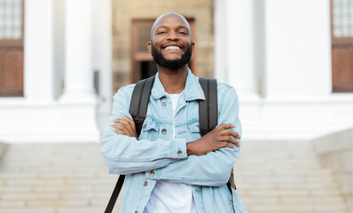 Portrait, education and proud man, university and student at campus for learning, future and goals....