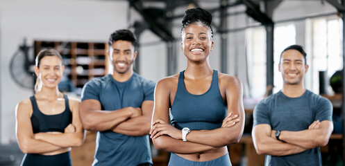 Fitness, portrait and woman personal trainer with a team standing with crossed arms in the gym....