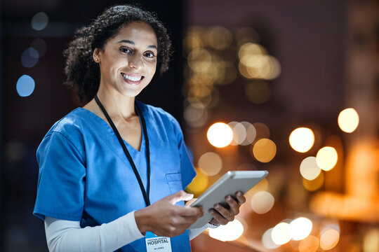 Tablet, City And Portrait Of A Doctor Working At Night On The Rooftop Of The Hospital Building In City. Medical, Lights And Woman Healthcare Worker Working Late On Mobile Device On Balcony Of Clinic.