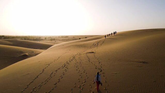 People on Mauritania Sahara Desert Sand Dunes at Sunset - Cinematic Aerial