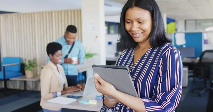 Portrait of african american businesswoman using tablet at office, slow motion