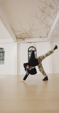 Vertical video of happy caucasian woman dancing in dance studio