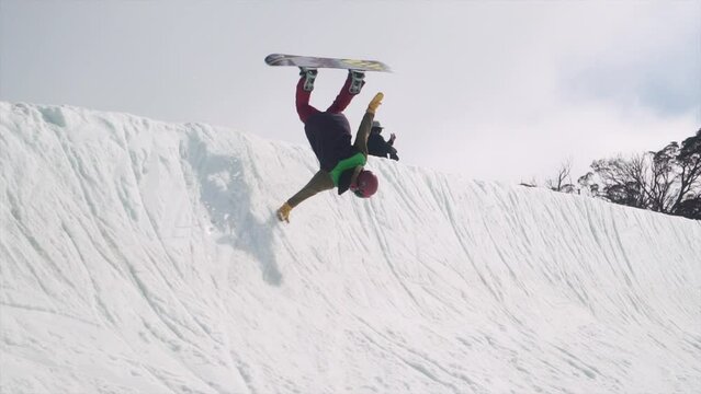 Young Australian Snowboarder performs halfpipe maneuver handplant snow spring blue bird day with mates at Perisher Front Valley Terrain Park July 2017 Jindabyne, Australia NSW by Taylor  Brant Film