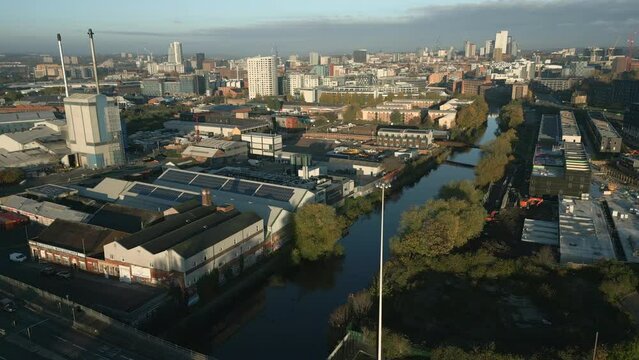 Establishing Shot of Leeds Inner City and City Centre with River Aire and Glass Manufacturing Factory at Morning Sunrise West Yorkshire UK