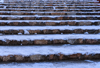 Ancient stone steps covered with slippery snow and ice after winter storm - 565236530