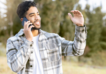 Phone call, man and relax while in a park for walking, calm and smile against a tree background. Smartphone, conversation and handsome male enjoying a walk in nature while talking, looking and fun