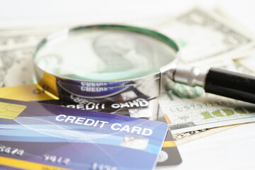 Credit card and magnifying glass for online shopping, security finance business concept.