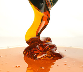Pouring golden honey on a white background