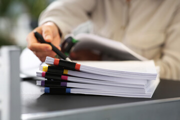 Businesswoman working with documents at grey table in office, closeup