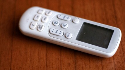 remote control AC (Air Conditioner) isolated on wooden background. copy space.