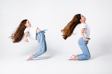 teenagers girls in jeans and white t-shirts synchronously perform dance moves on a white background