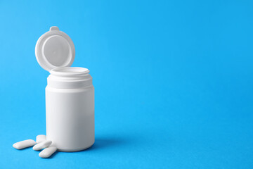 Jar with chewing gums on light blue background. Space for text