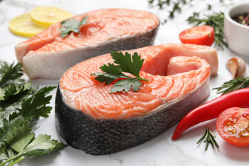 Fresh salmon and ingredients for marinade on white marble table, closeup