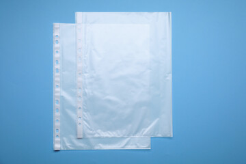 Punched pockets on light blue background, flat lay