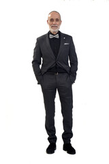 front view of a man standing with suit and  bow tie  looking at camera and two hand on pocket on white background