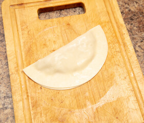 Cooking chebureks from dough and minced meat.