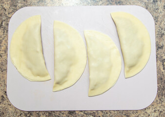 Cooking chebureks from dough and minced meat.