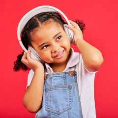 Happy, kid and headphones for music, radio and fun podcast on isolated red background and dancing...