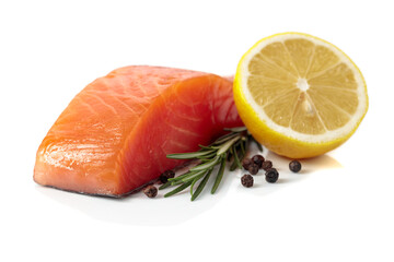 Salmon piece with rosemary, lemon, and peppercorn isolated on a white background.