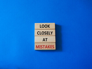 Look closely at mistakes symbol. Wooden blocks with words Look closely at mistakes. Beautiful blue background. Business and Look closely at mistakes concept. Copy space.