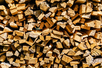 Photography on theme big wall of stacked oak tree logs in cracks