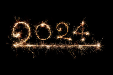 Happy New Year 2024. Burning sparkling text 2024 isolated on black background. Beautiful glowing design element for greeting card and holiday flyer. Text 2024 written with sparklers for holiday design
