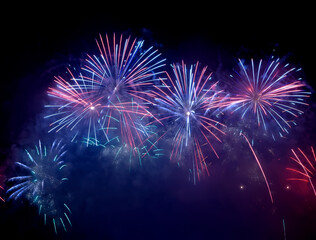 Beautiful blue and pink fireworks display lights up the sky with dazzling display during New Year...