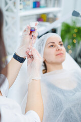 A young woman at an appointment with a beautician, beauty injections for the face. Treatment procedure at a dermatologist