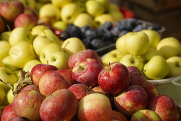 A huge number of fresh apples of different varieties on a big sale
