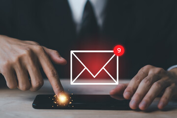 Businessman hands hold smartphone and touch email icon and send e-mail or newsletter. Electronic...