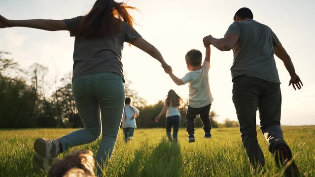 Happy family on grass with pet. Picnic in park with dog. Summer vacation on green meadow.People play run on grass.Family run in nature holding hands.Animal love for people.Family walk with dog in park