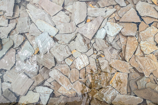 Background image of a broken stone slab at the bottom of a well.