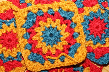 Fototapeta na wymiar Yellow, Red and Blue Crochet Granny Squares 