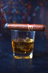 A Night of Decadence: Whiskey on the Rocks with a Lit Cuban Cigar in a Smoky Nighttime Bar or Club Setting
