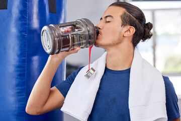Fototapeta na wymiar Fitness, man and drinking water in gym for health, rest and energy for boxing, workout and towel. Thirsty sports person, bodybuilder and athlete hydration, bottle and exercise nutrition for wellness