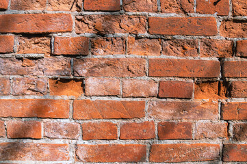 Brickwork on the wall of an old house built in the 19th century. The background is made of old brick. Full-bodied clay brick. Material for building construction.