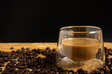 Creamy coffee milk with organic coffee beans on the wooden table